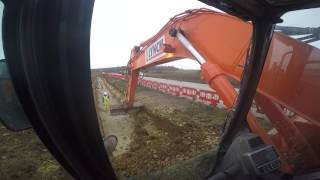 Doosan DX235LCR excavator digging out a service trench [upl. by Marcos]