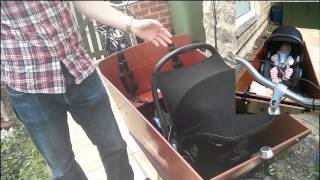 Carrying an infant in a Bakfiets using maxi cosi and rain tent [upl. by Nnylg742]