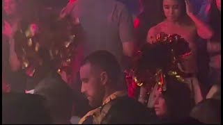 Travis Kelce glugs champagne while surrounded by scantily clad women in Las Vegas after flying to [upl. by Andromede]