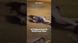 Woman blown to ground by strong winds in Hong Kong [upl. by Rodrick]