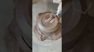 Ceramics artist is trimming the base of a pottery cup [upl. by Airym755]