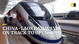 Laos takes delivery of train as new Chinafunded Belt and Road railway nears completion [upl. by Suhpoelc]