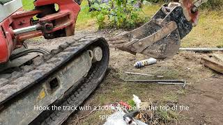 How to fix minidigger excavator tracks back on  the EASY WAY in a few minutes Takeuchi TB216 [upl. by Yeldahc]