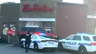 Wild getaway attempt at Tim Hortons drivethru  Suspect drives over police cruiser [upl. by Monjan]