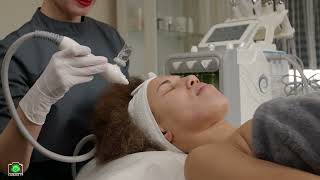 Lovely black woman getting hydra pores cleaning procedure by cosmetician [upl. by Naejeillib]