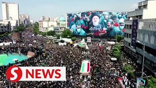 Iranian mourners march through Tehran streets bid farewell to president [upl. by Marielle199]