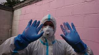 Masked Lady In Full Coverall Rubber Gloves Painting Wall [upl. by Riddle]