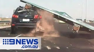 Shocking moment freeway sign CRUSHES car  Nine News Australia [upl. by Alleuol]