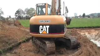 cat 312c excavator excavating a silt pond [upl. by Sheply]