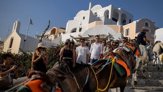 Greeces Santorini bursts with tourists as locals seek cap  REUTERS [upl. by Liauqram66]