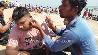 Ear cleaner plies his trade on Puri beach in Odisha cleaning ears on sandy shore of Bay of Bengal [upl. by Yleek]