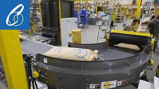 High Speed Robotic Bag Palletizer System with a Bag Flattener and Curved Infeed Conveyor [upl. by Lefton]