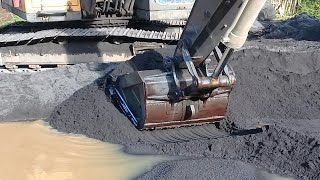 excavators work to dredge sand and load it into trucks  sand mining [upl. by Chrisy]