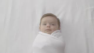 how to swaddle a baby  safe  easy swaddling technique  aden  anais™ [upl. by Enelhtak]