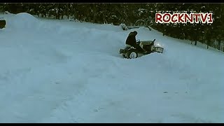 Garden tractor plowing deep snow Pushing up the bank ns [upl. by Norre911]