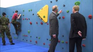 The Prince of Wales tries out a climbing wall at Grainville School in Jersey [upl. by Trey389]