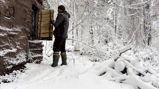 Staying in a shelter during a snowstorm Spending the night in a bushcraft shelter winter camping [upl. by Oicnerual]