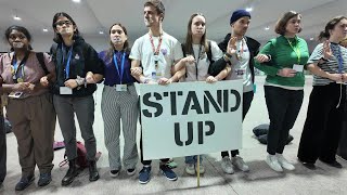 Protesters demonstrate outside COP29 closing plenary  AFP [upl. by Asillem]