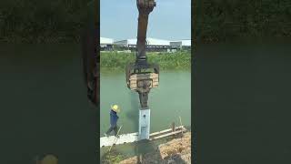 Driving concrete sheet piles using Top Grip Excavator Sheet Pile Driver [upl. by Eugine]