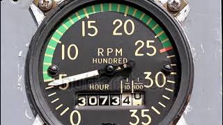 stock footage mechanical aircraft tachometer and hour meter on a gray panel swings wildly [upl. by Rubenstein]