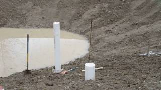 Setting the footings for the dock in the pond [upl. by Town]