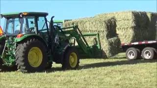 Loading And Hauling Large Square Bales With A John Deere 5085M amp 6300 [upl. by Fairfield]