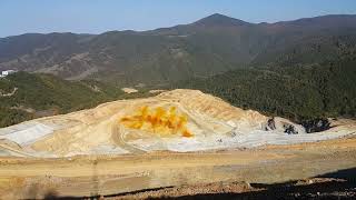 Smoke and dust after a blasting operation in an open pit copper mine [upl. by Dunning]