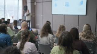 Audience attentively listening to a speaker in a conference room [upl. by Nosdivad]