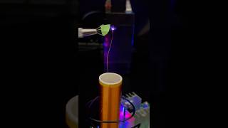 Tesla coil exiting mediums my finger neon gas ion glass and a scintillator crystal shorts [upl. by Llennahs]