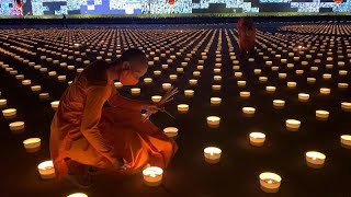 Buddhist monks light candles on Visakha Bucha Day [upl. by Valentine]