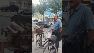 A knife sharpener solicits customers on the street [upl. by Nevets]