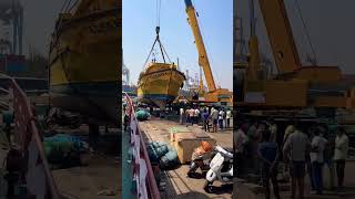 Lifting boat from water to jetty in fishing harbour [upl. by Ennaihs992]