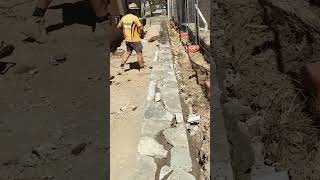 Sealing the top of this recycled concrete retaining wall with a dyed mortar shorts construction [upl. by Port693]