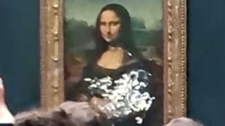 Climate protester throws cake at Mona Lisa painting [upl. by Sessler955]